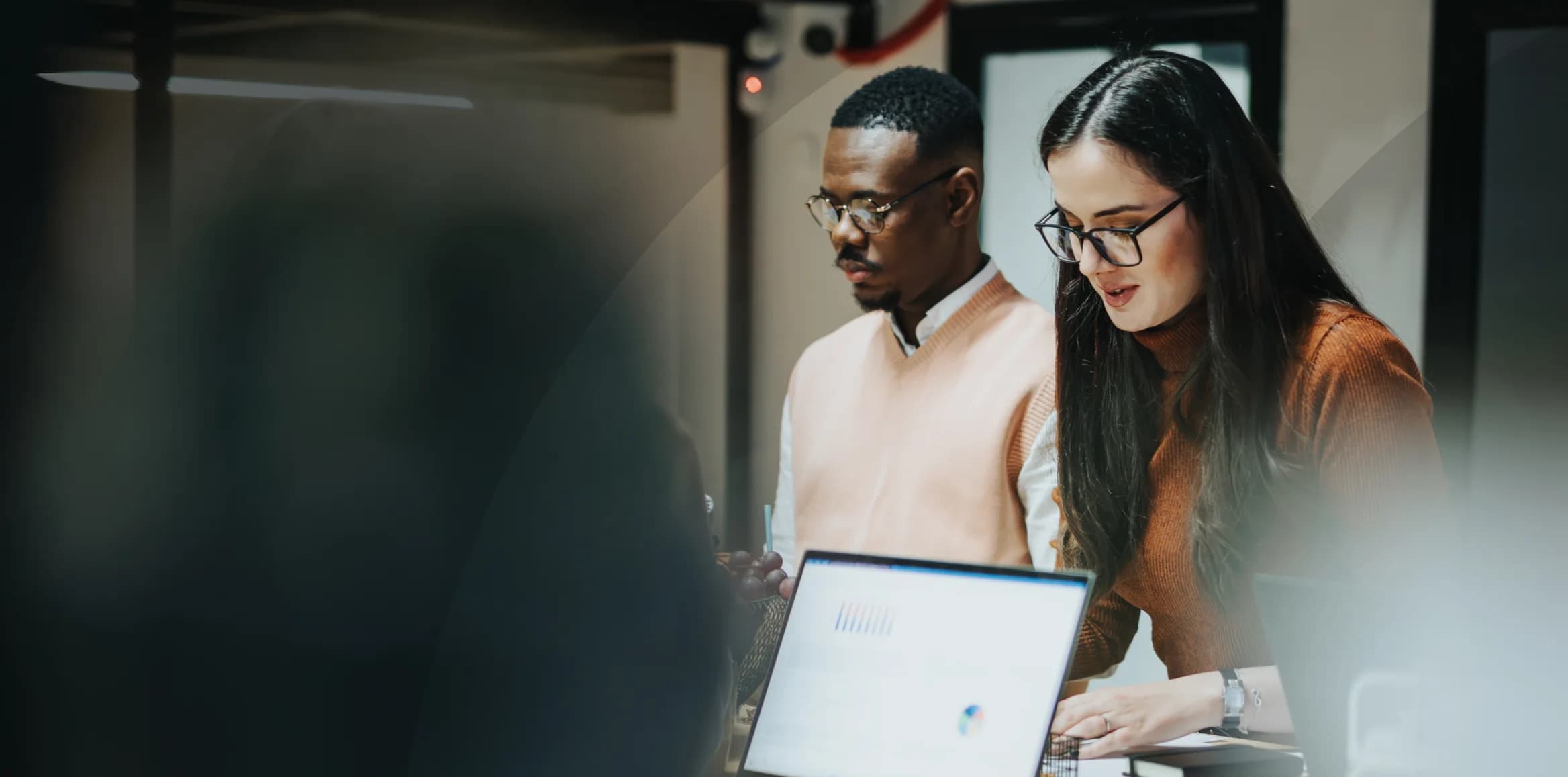 Focused engineers collaborating at a workspace